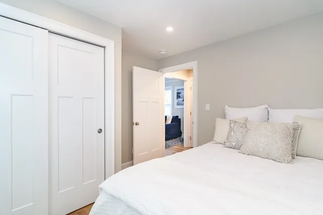 a bedroom with a bed and a painting on the wall