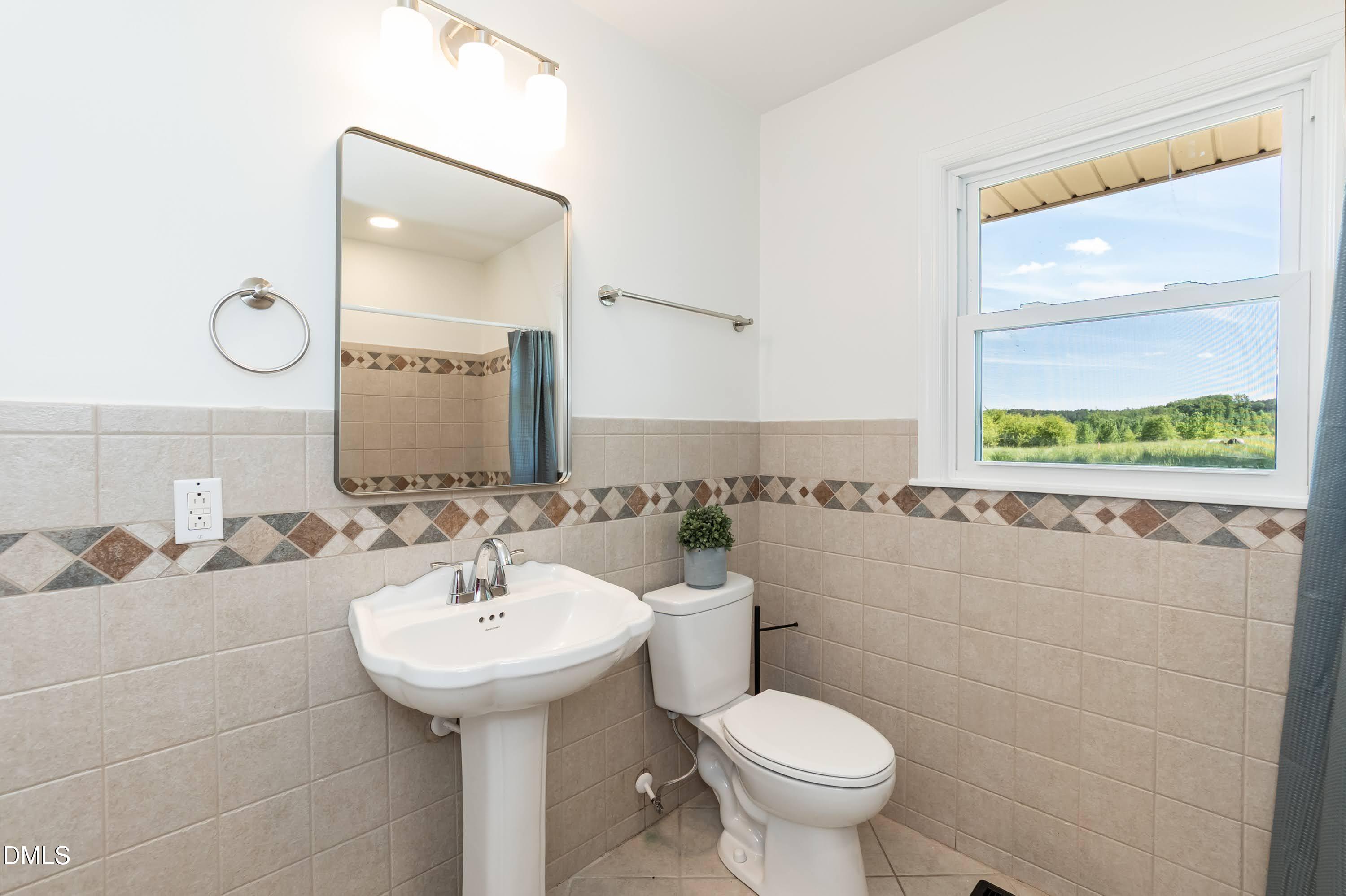 641 Rocky Ford Road Louisburg, NC 27549 - Photo 16 of 38 a bathroom with a sink and a mirror
