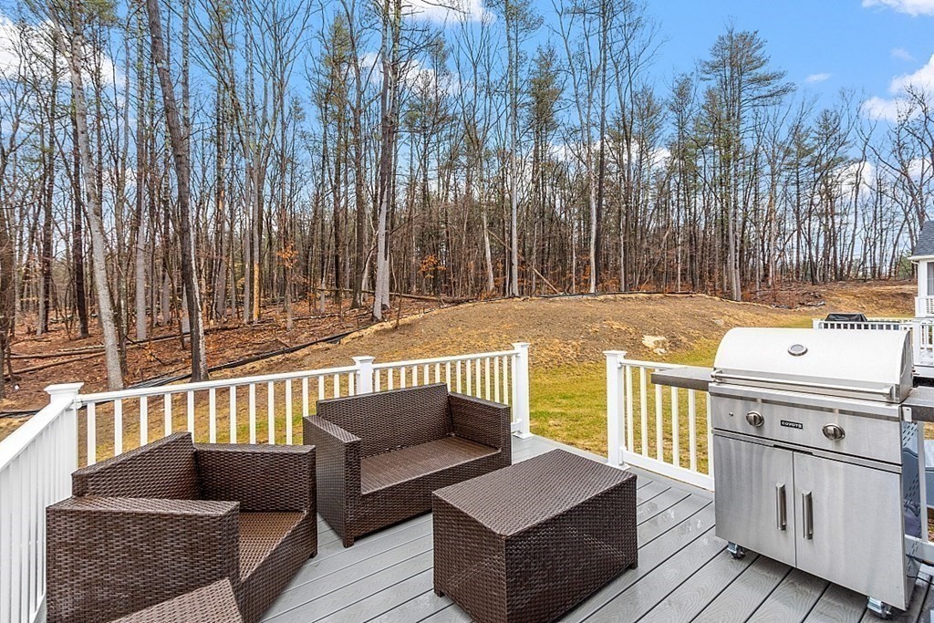 7 Wheeler Hill Road, Unit 4 Berlin, MA 01503 - Photo 36 of 36 a roof deck with couches and wooden fence