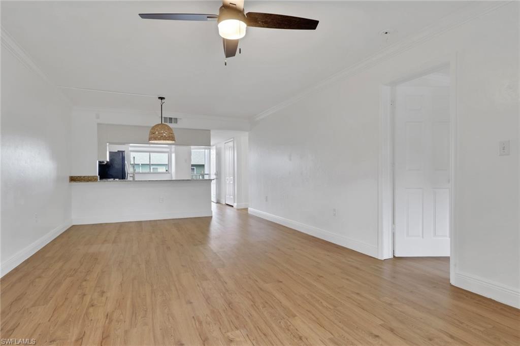 146 Cypress Way East, Unit 7 Naples, FL 34110 - Photo 11 of 27 a view of empty room with wooden floor