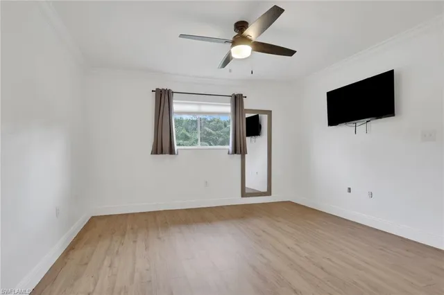 a view of room with ceiling fan and window