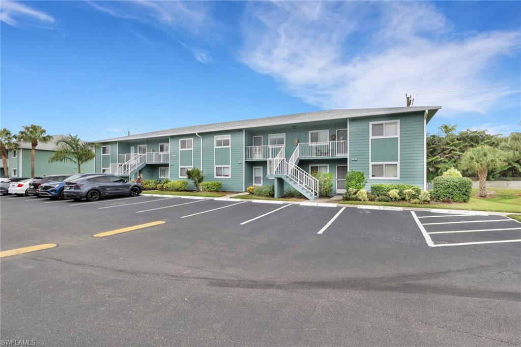 146 Cypress Way East, Unit 7 Naples, FL 34110 - Photo 24 of 27 a view of street with cars