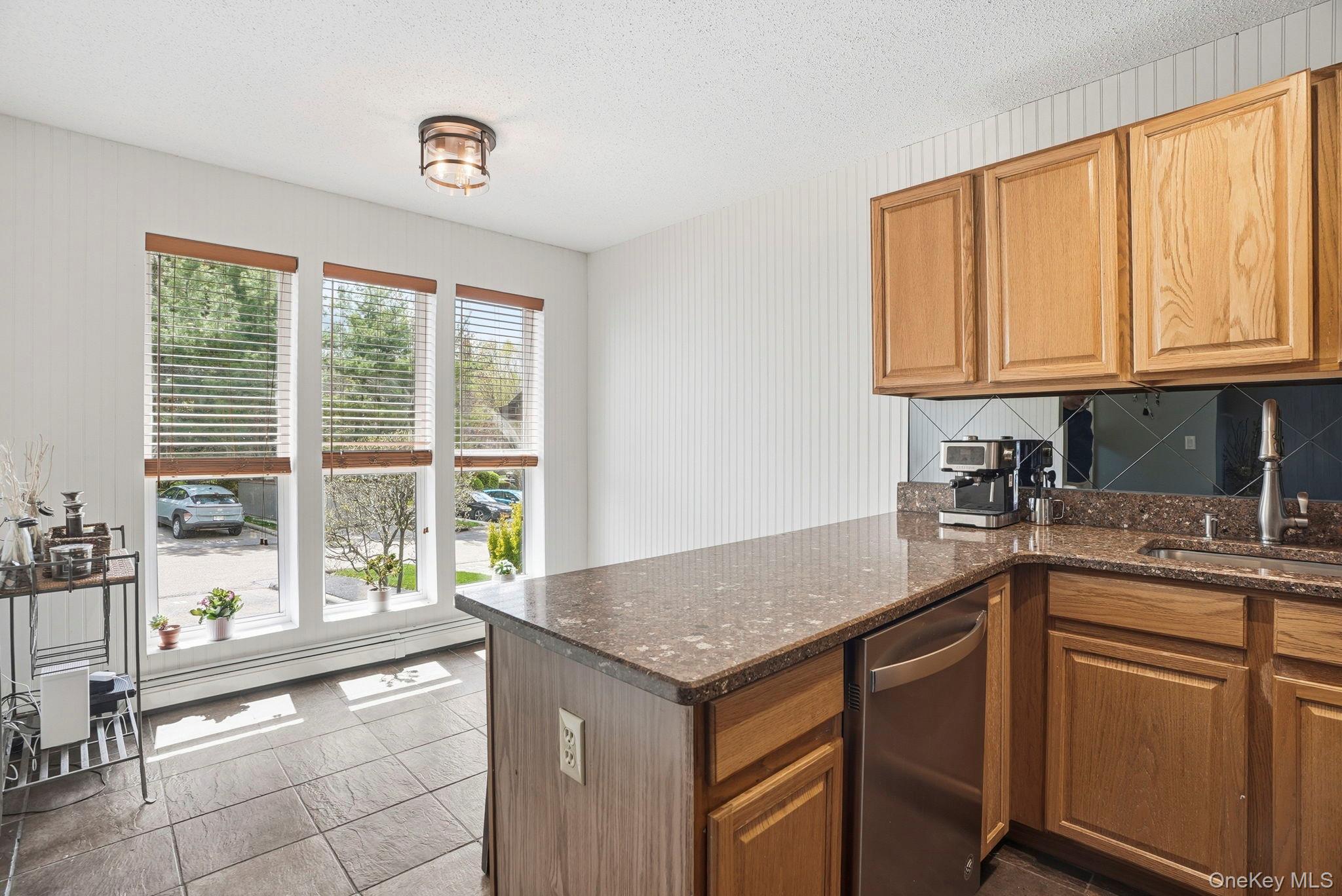 85 Hemlock Circle Peekskill, NY 10566 - Photo 5 of 23 Tall windows flood the kitchen with light. This would also be a great space to use as a dedicated home office too.