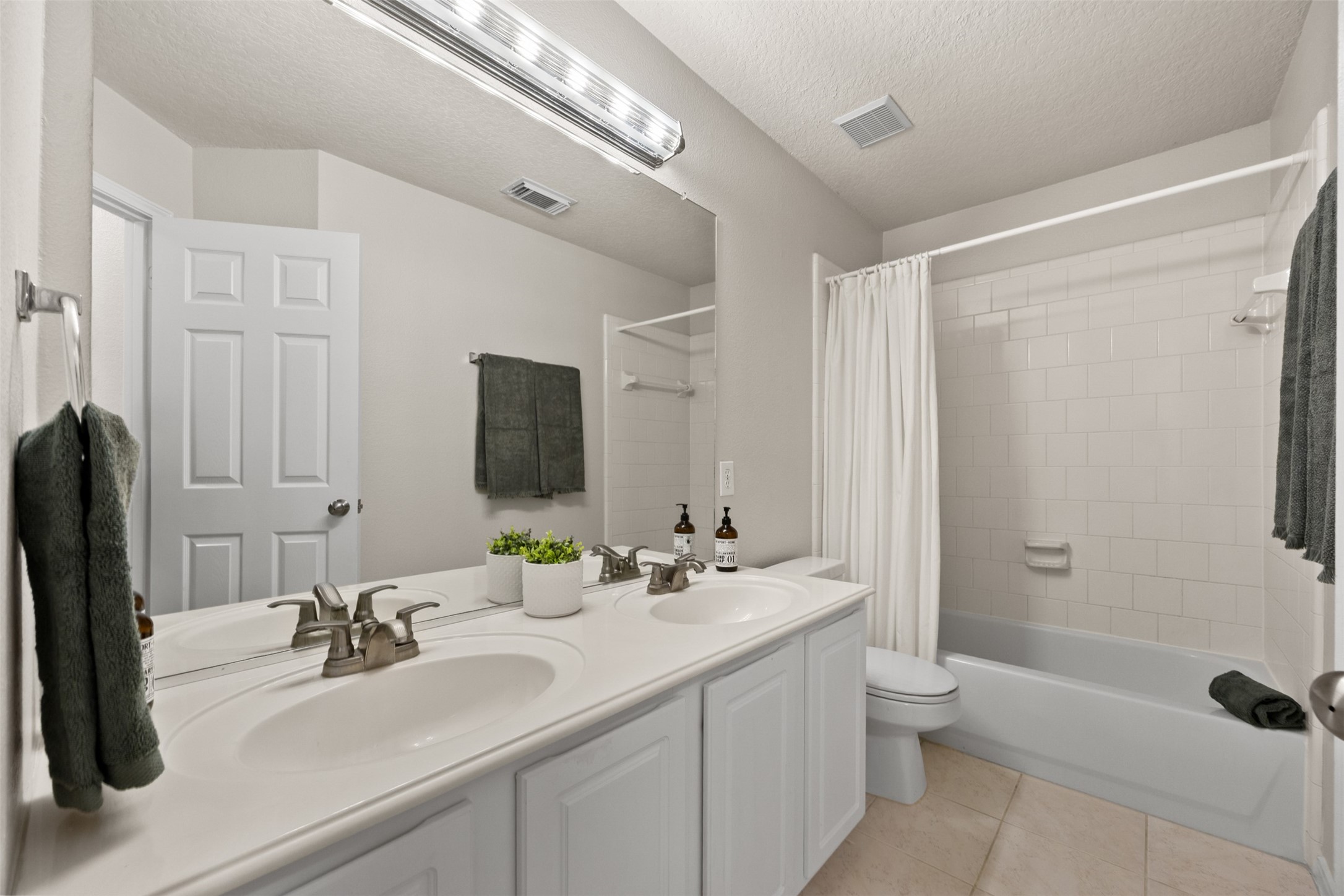 2219 Louetta Brook Lane Spring, TX 77388 - Photo 32 of 34 Full bathroom with double sinks, large mirror, and tub/shower combo.