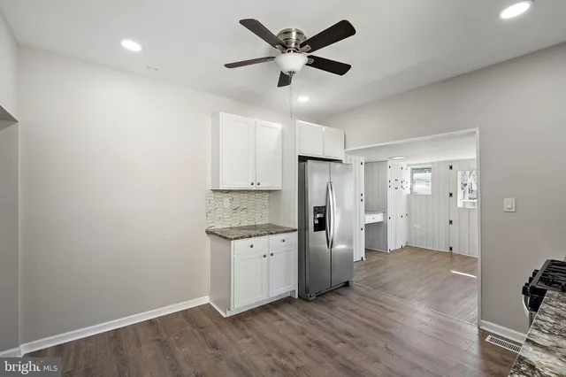 a kitchen with stainless steel appliances a refrigerator and a stove top oven