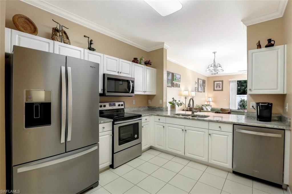 a kitchen with stainless steel appliances granite countertop a refrigerator sink and stove top oven