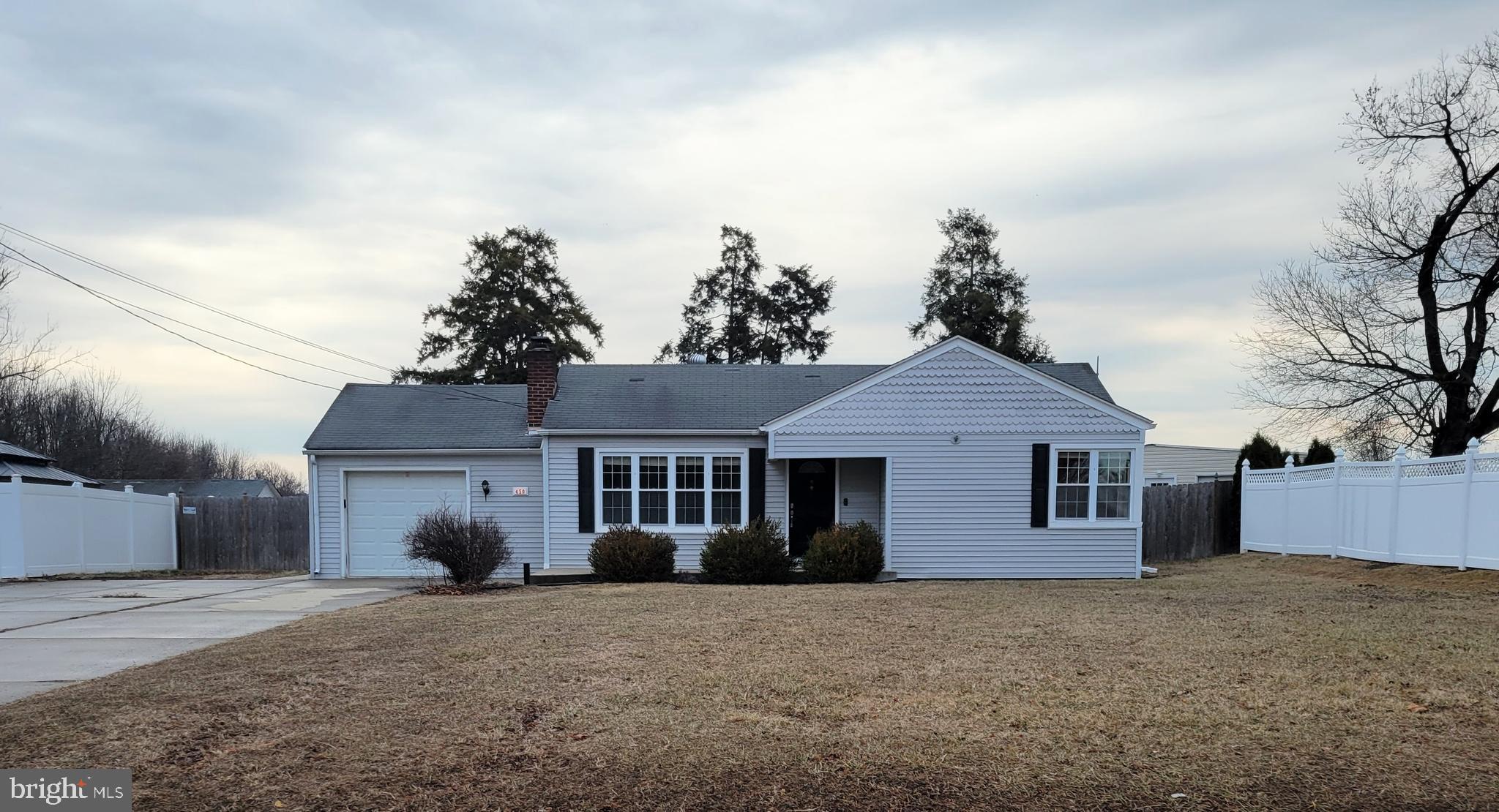 450 Tansboro Road Berlin, NJ 08009 - Photo 1 of 25 a front view of a house with a yard and garage