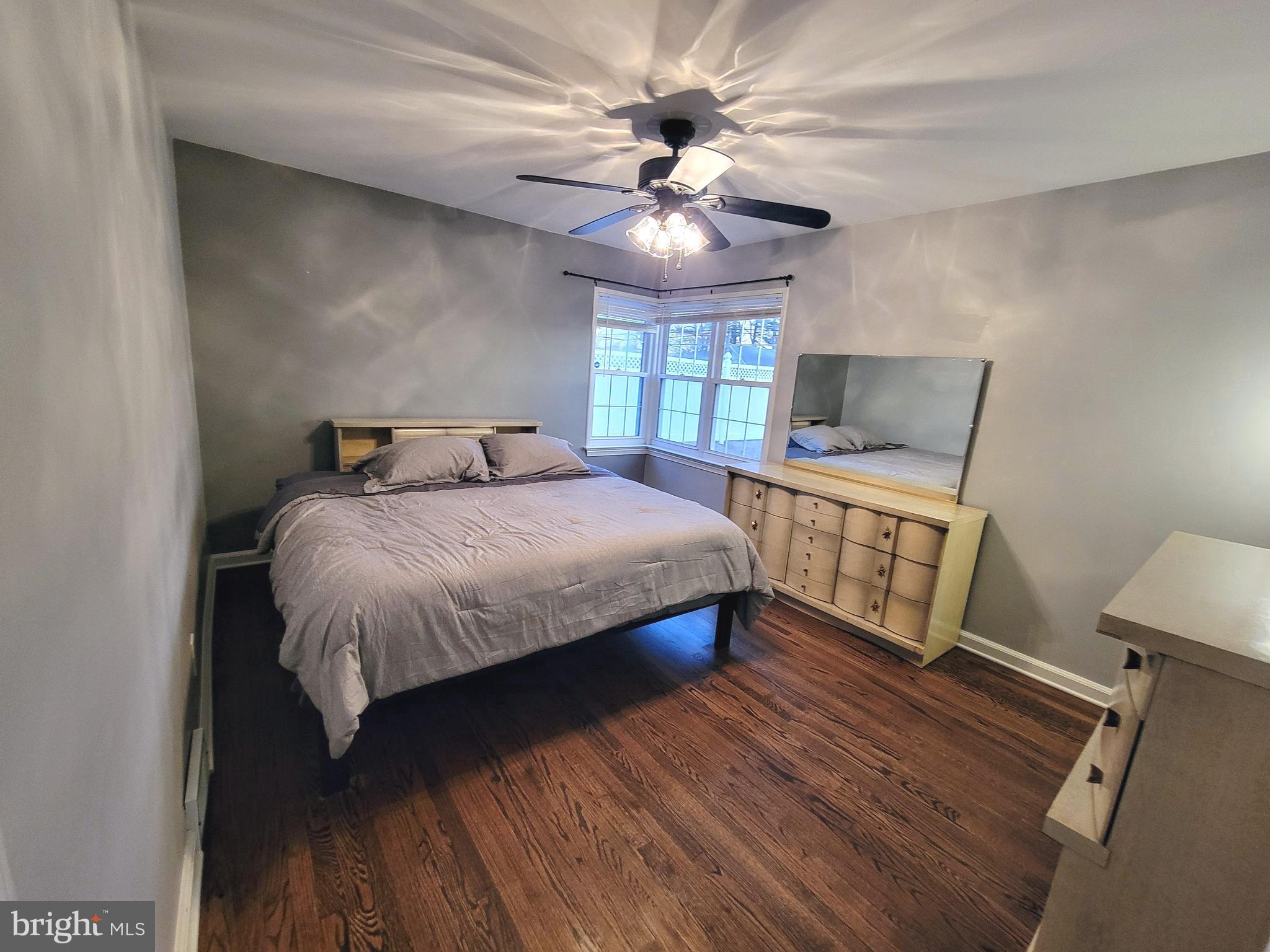 450 Tansboro Road Berlin, NJ 08009 - Photo 12 of 25 a bedroom with a large bed chandelier and a window