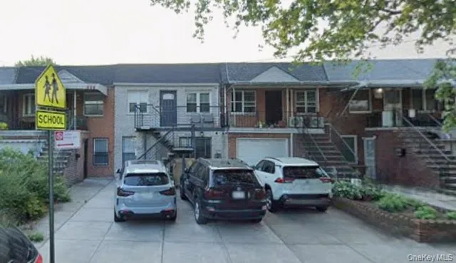 a view of a patio with table and chairs potted plants and a large tree