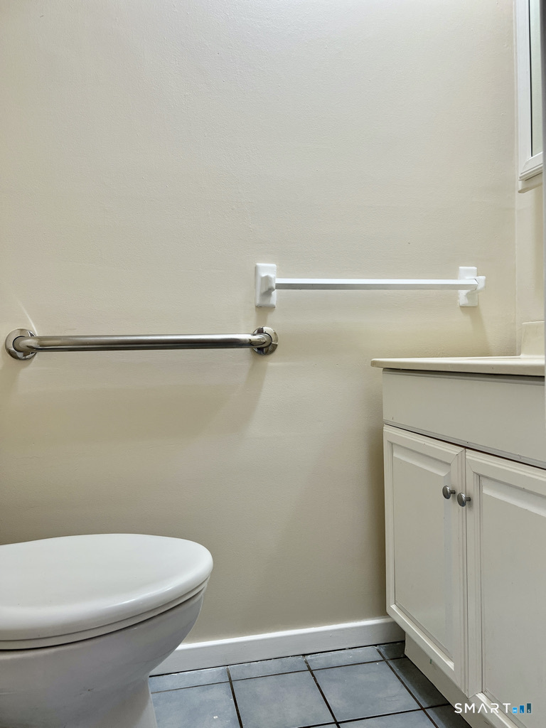 8 Roma Street, Unit 8 East Haven, CT 06512 - Photo 19 of 26 a white toilet sitting next to a bathroom sink