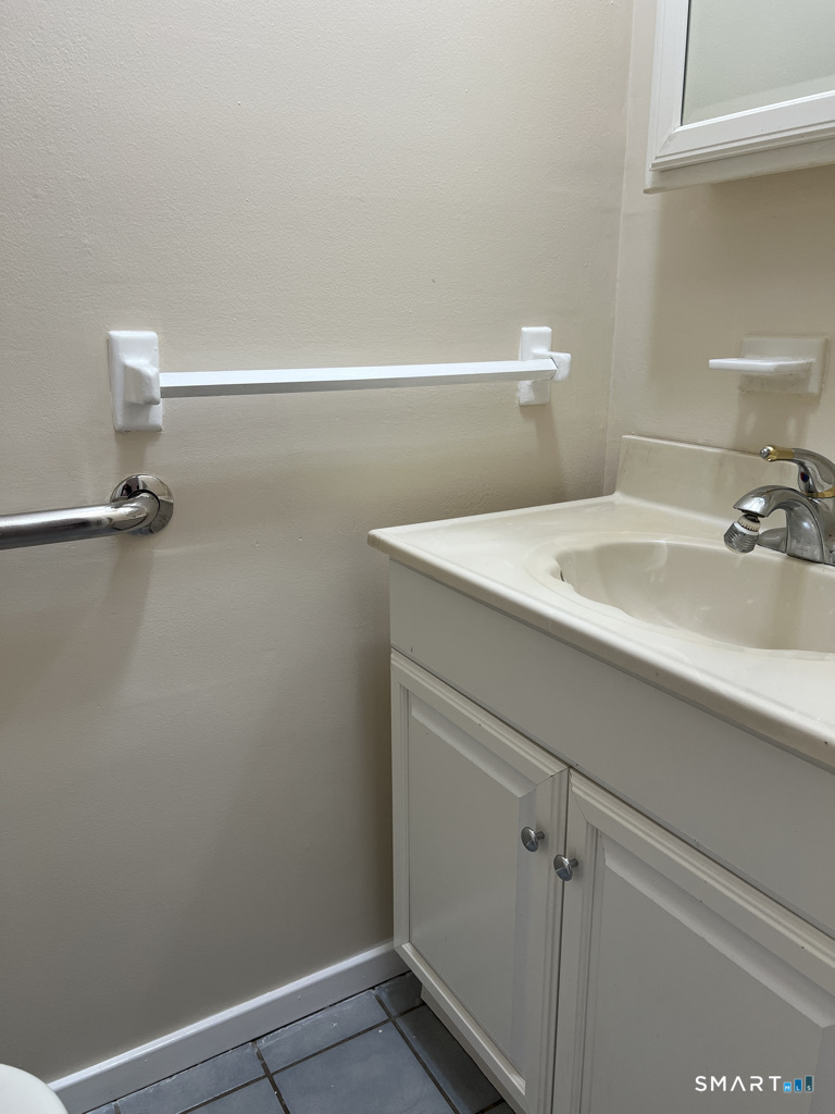 8 Roma Street, Unit 8 East Haven, CT 06512 - Photo 22 of 26 a bathroom with a sink and vanity