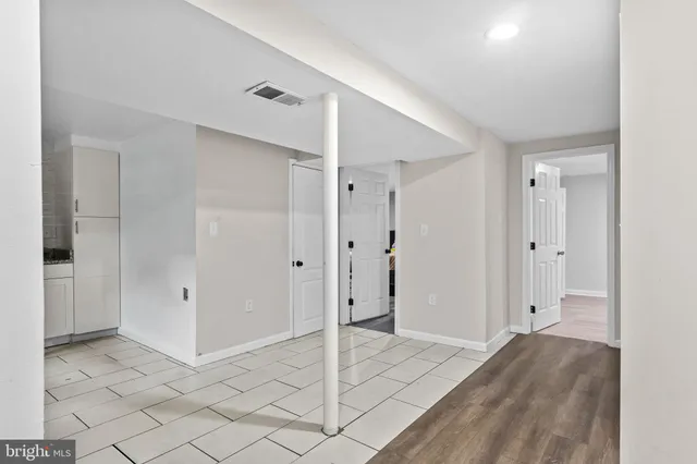 a view of a hallway with wooden shelves