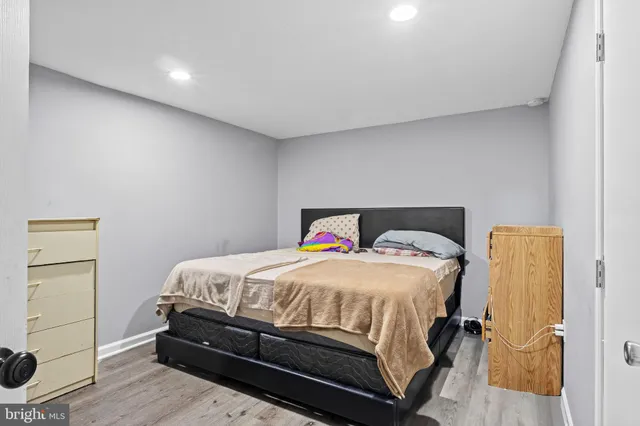 a bedroom with a bed and wooden floor