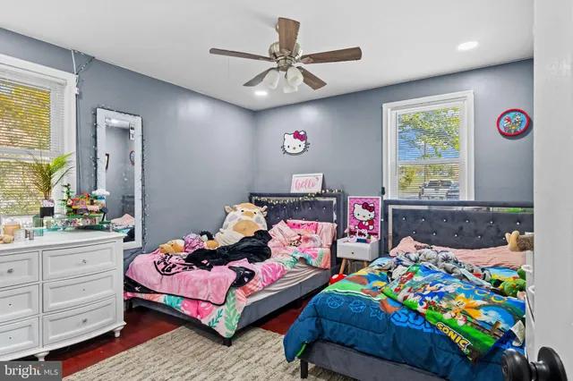 a bedroom with two beds and a chandelier