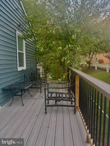 a view of a wooden deck with furniture