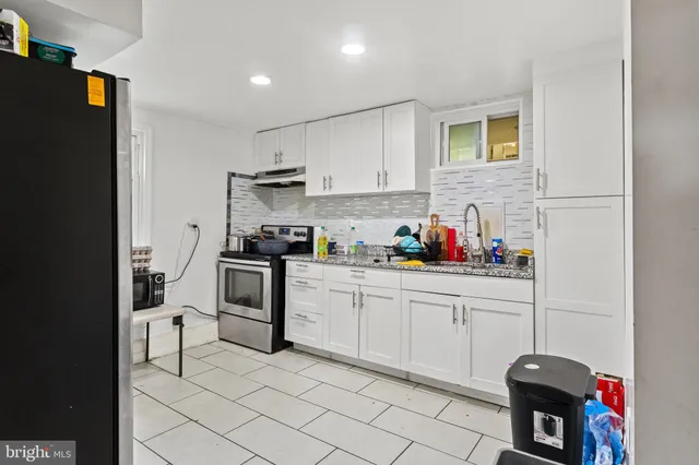 a kitchen with granite countertop cabinets and appliances