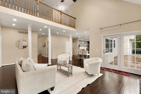 a spacious bedroom with a bed and a chandelier