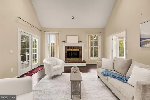 a spacious bathroom with a double vanity sink a mirror and a bathtub