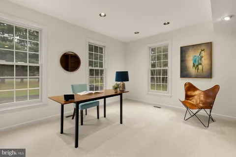 a view of a livingroom with a ceiling fan and bathroom