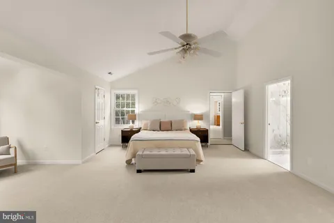 an empty room with a window and a ceiling fan