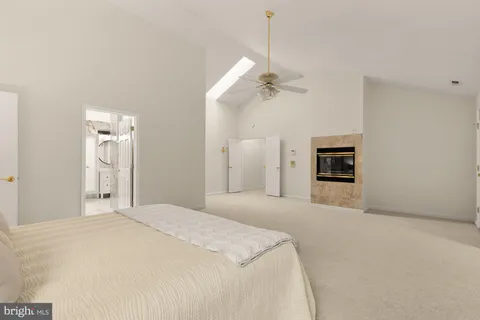 a view of an empty room with a chandelier fan