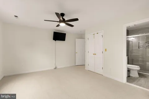 a bathroom with a toilet sink double vanity and mirror