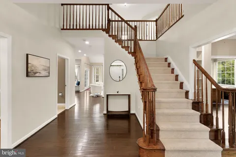 a view of an entryway with wooden floor and stairs