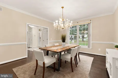 a kitchen with a table chairs stove and cabinets