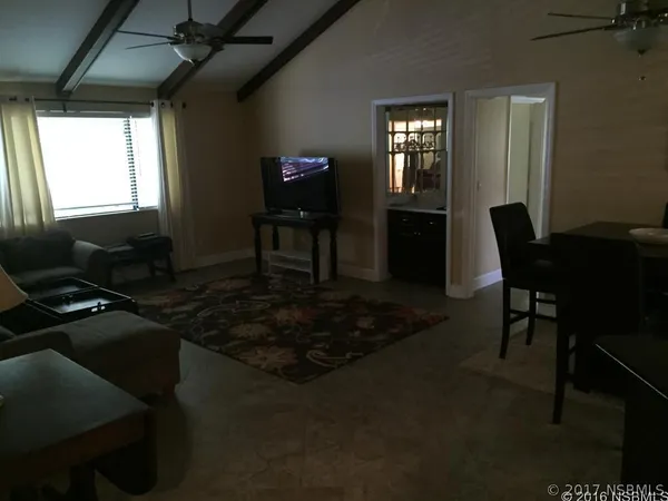 a kitchen with stainless steel appliances kitchen island granite countertop a refrigerator a stove and a sink