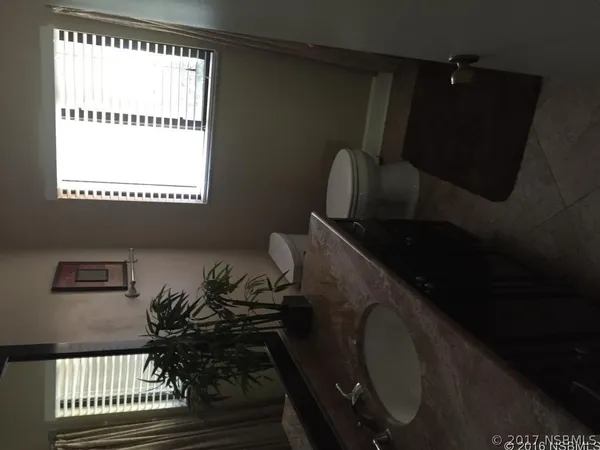 a view of a living room and floor to ceiling window