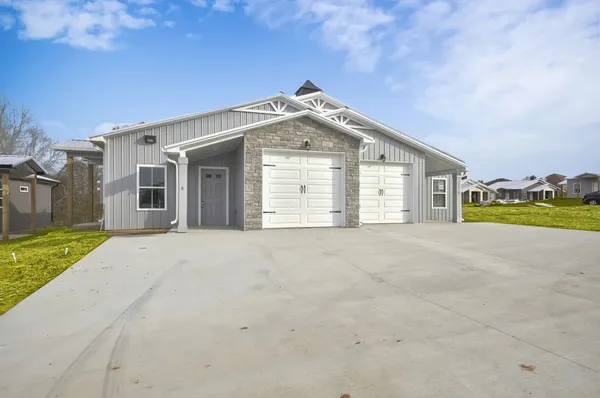 a view of a house with a yard and garage