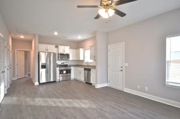 a view of a kitchen with a stove cabinets and wooden floor