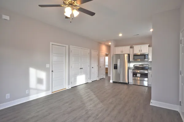 a kitchen with stainless steel appliances granite countertop a refrigerator and a sink