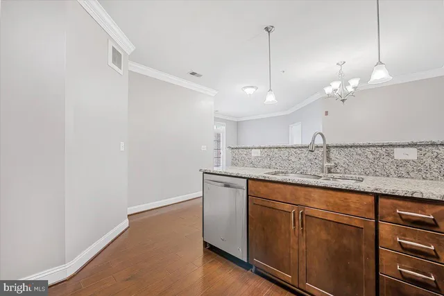a bathroom with a granite countertop sink and white cabinets