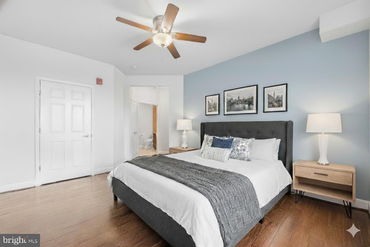 3911 Doc Berlin Drive, Unit 14 Silver Spring, MD 20906 - Photo 27 of 33 a bedroom with a bed and a chandelier