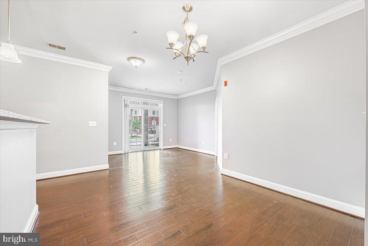3911 Doc Berlin Drive, Unit 14 Silver Spring, MD 20906 - Photo 9 of 33 wooden floor in an empty room with a window