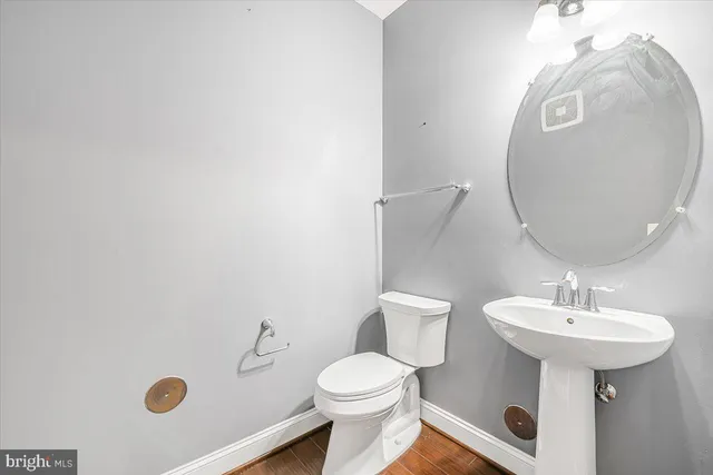 a bathroom with a sink a mirror and toilet