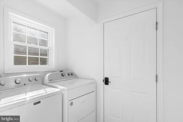 an empty room with windows and a fireplace