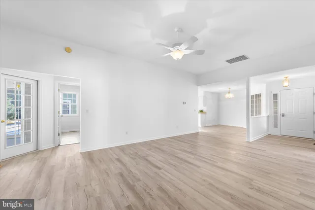 a spacious bedroom with a large bed and a large window