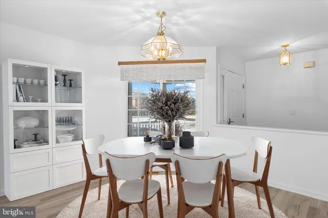 a view of a hallway with wooden floor and a living room