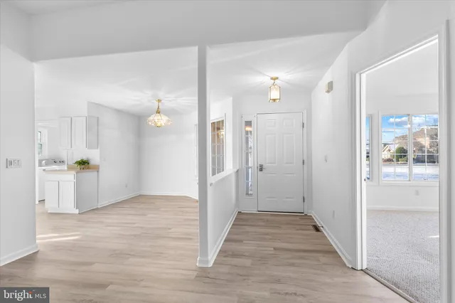 a living room with furniture a fireplace and a chandelier