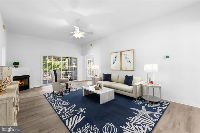 a kitchen with stainless steel appliances granite countertop a sink a stove cabinets and wooden floor