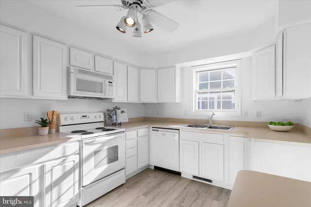 a kitchen with a stove a sink and a refrigerator