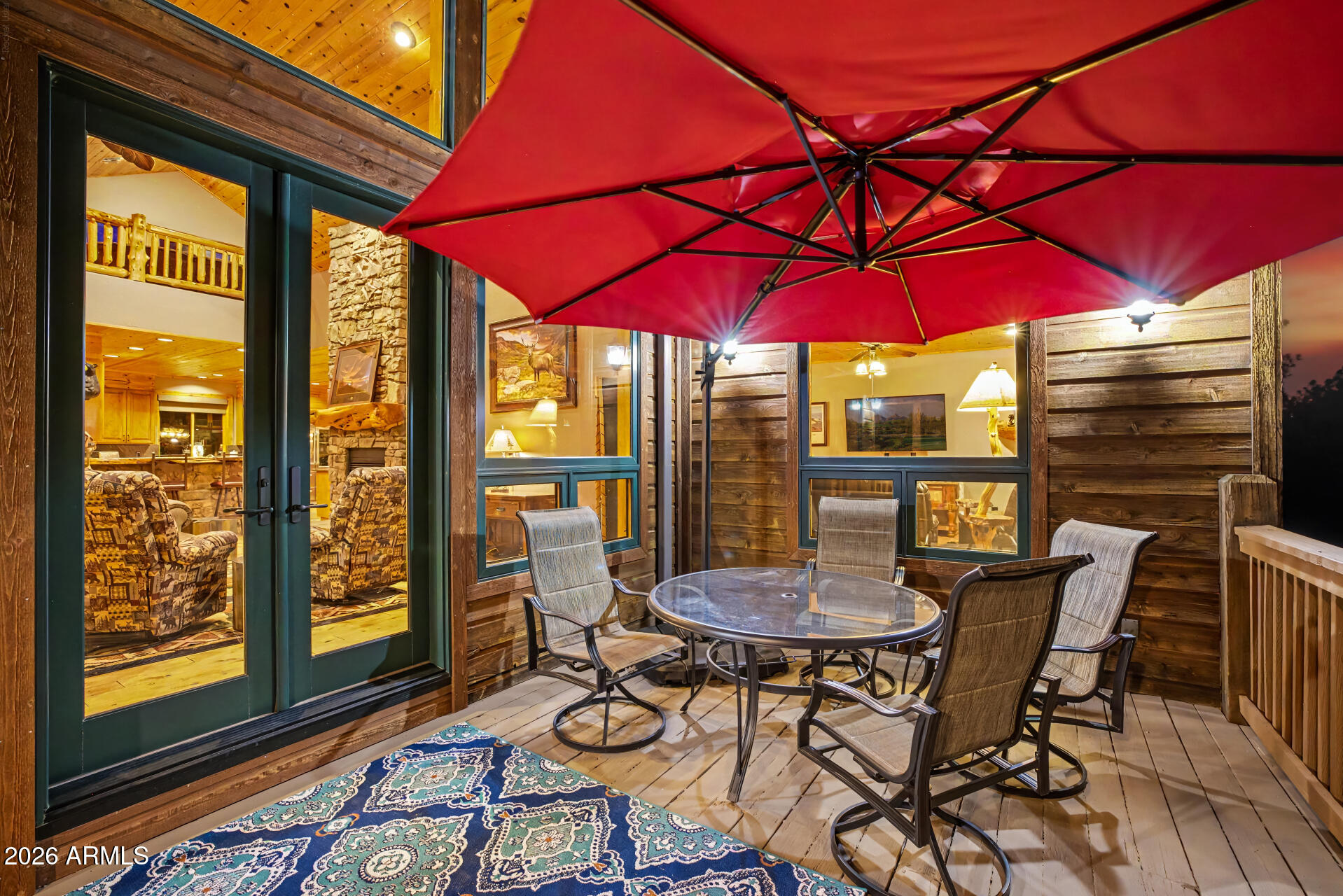 1681 South Jimson Loop Show Low, AZ 85901 - Photo 73 of 105 a view of a patio with table and chairs under an umbrella