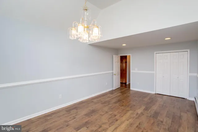 a view of a room with wooden floor and ceiling fan