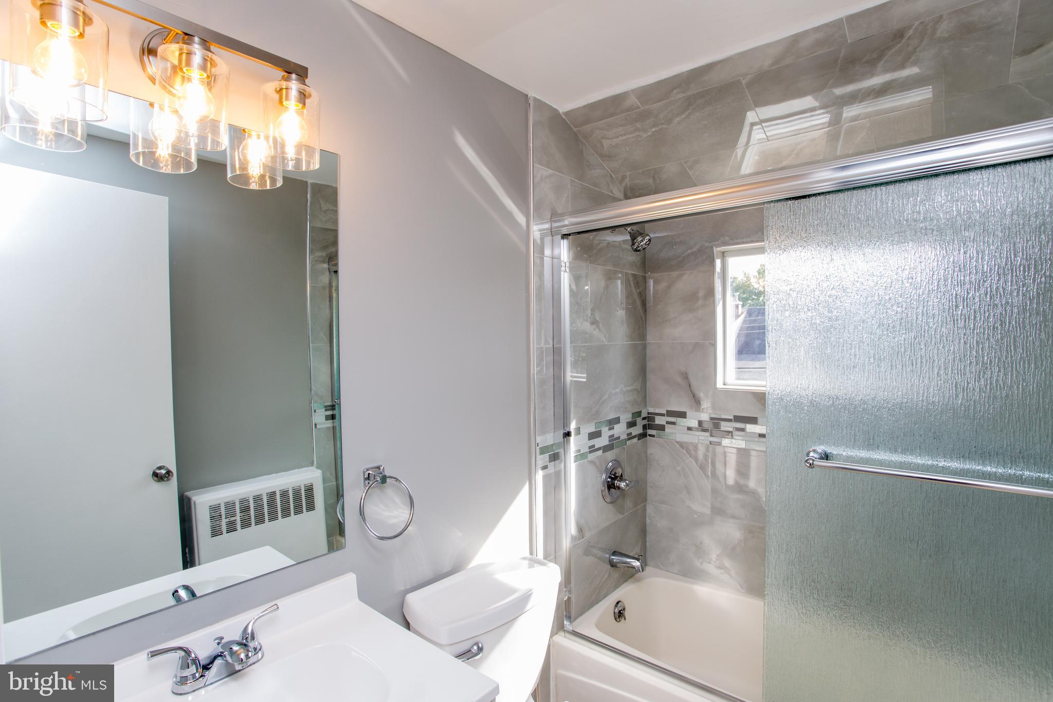 23 Misty Pine Road Levittown, PA 19056 - Photo 51 of 74 a bathroom with a granite countertop shower mirror and a sink