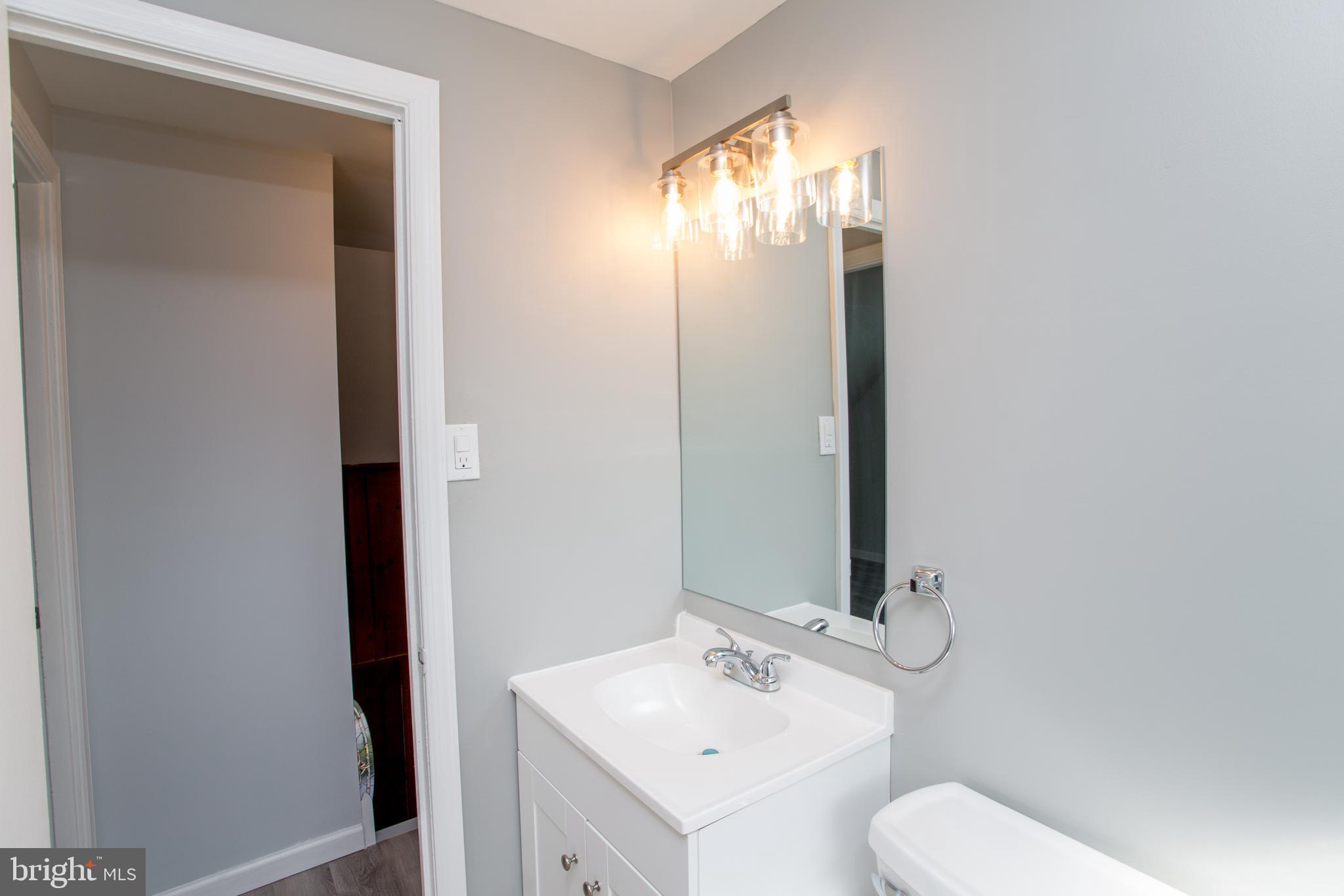 23 Misty Pine Road Levittown, PA 19056 - Photo 52 of 74 a bathroom with a sink and mirror with toilet