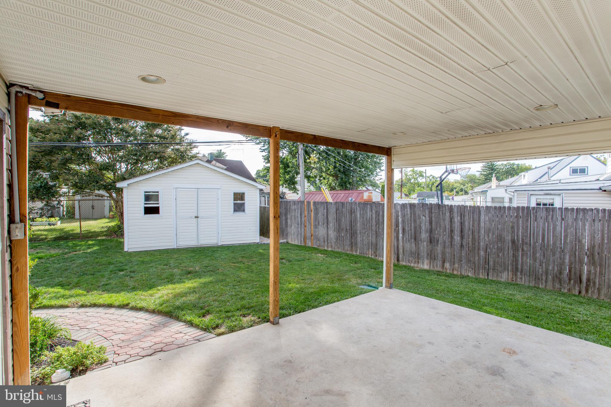 23 Misty Pine Road Levittown, PA 19056 - Photo 56 of 74 a view of a backyard with plants and large trees with wooden fence