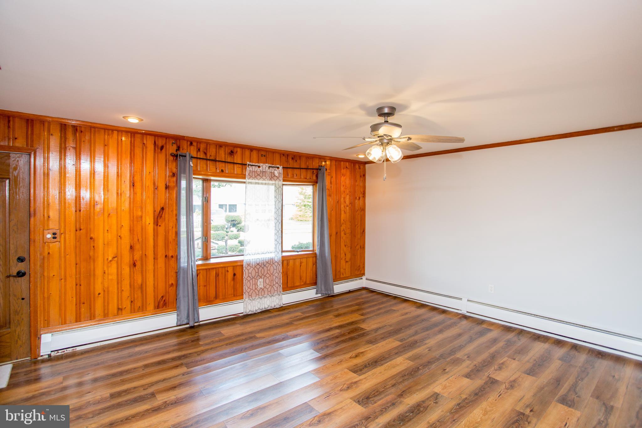 23 Misty Pine Road Levittown, PA 19056 - Photo 8 of 74 a view of an empty room with a window and wooden floor