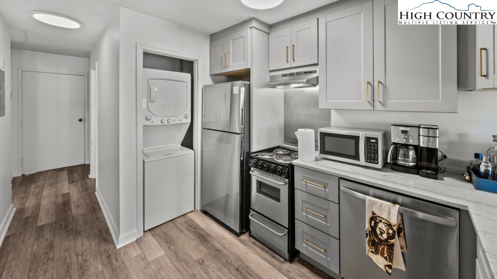 301 Pinnacle Inn Road, Unit 1114 Beech Mountain, NC 28604 - Photo 13 of 19 a kitchen with stainless steel appliances a refrigerator a stove and white cabinets